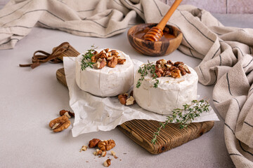 Brie or camembert cheese with thyme, nuts and honey