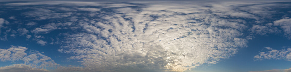 Panorama of a dark blue sunset sky with golden Cumulus clouds. Seamless hdr 360 panorama in spherical equiangular format. Full zenith for 3D visualization, sky replacement for aerial drone panoramas.