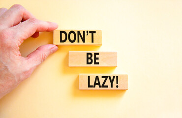 Motivational and do not be lazy symbol. Concept words Do not be lazy on wooden blocks on a beautiful white table white background. Businessman hand. Business do not be lazy concept. Copy space.