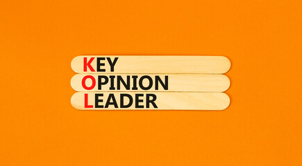 KOL key opinion leader symbol. Concept words KOL key opinion leader on wooden sticks on beautiful orange table orange background. Business KOL key opinion leader concept. Copy space.