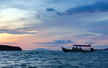 Colorful sunset sky with silhouette of boat in Langkawi island, Andaman sea, Malaysia