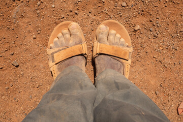 Lower section of a man wearing a dirty pair of shoes at Chalbi Desert, Marsabit County