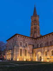 Fototapeta na wymiar Vertical landscape view of famous landmark St Sernin basilica illuminated after sunset, Toulouse, France 