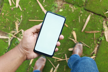  POV shot of young man using smart phone at outdoor 