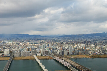 Fototapeta premium Overhead view of Osaka's Umeda area from a hill on a cloudy day