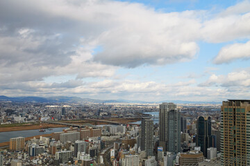 Naklejka na ściany i meble Overhead view of Osaka's Umeda area from a hill on a cloudy day