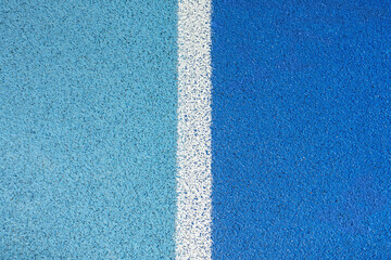 part of the athletic field with a vertical white line. top view. Texture of color rubber floor on...