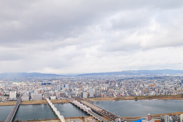 Overhead view of Osaka's Umeda area from a hill on a cloudy day