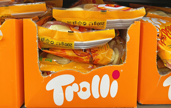 Viersen, Germany - December 9. 2022: Closeup of bags trolli candy in shelf of german supermarket