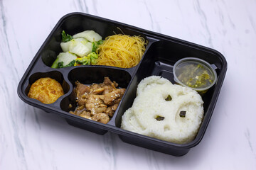 selective focus Ready to eat asian rice bento box, Indonesia food in take away plastic boxes