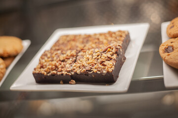 Delicious sweets and cookies made of black and brown chocolate on the festive table