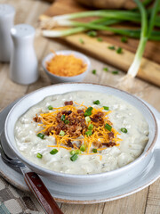 Cream of potato soup with bacon, cheese and green onions