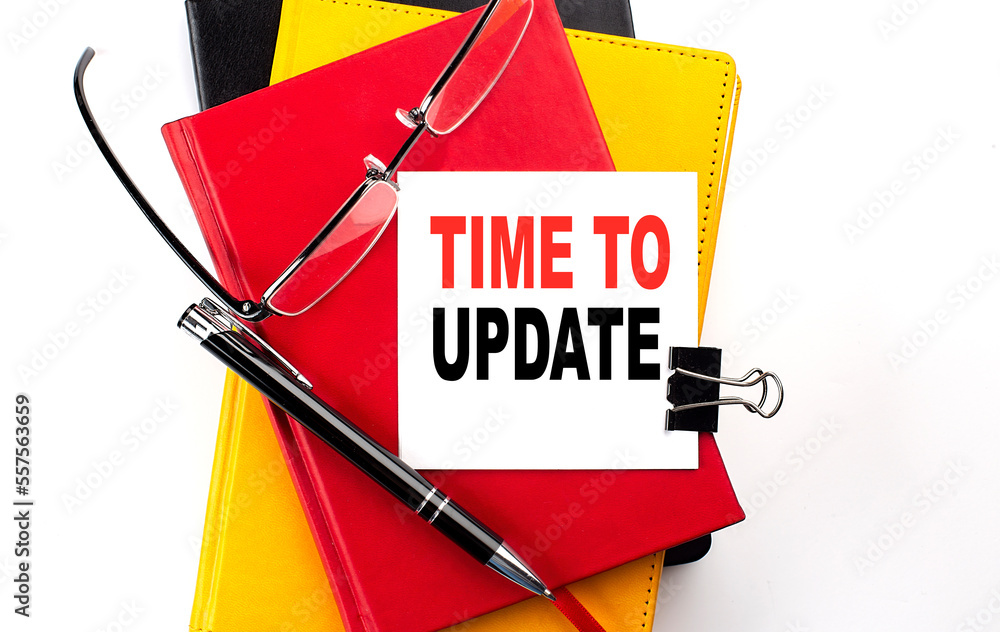 Poster time to update text written on a sticky on colorful notebooks