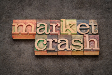 market crash word abstract in letterpress wood type against black textured paper, business, economy and recession concept