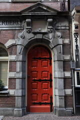 Amsterdam Gravenstraat Street Historic Red Wooden Door with Sculpted Details, Netherlands