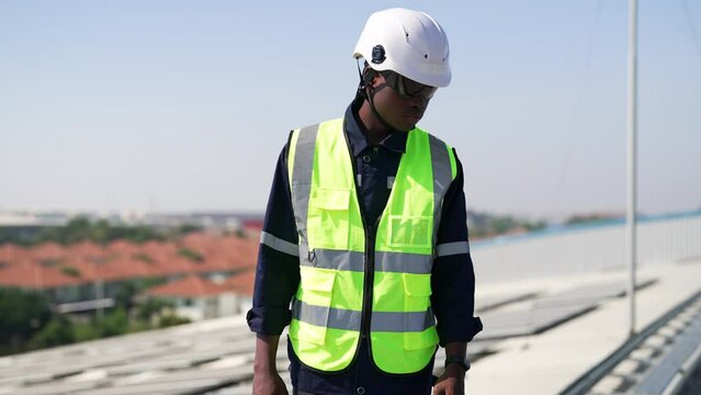 Engineer on rooftop walking next to solar panels photo voltaic check alignment for good installation
