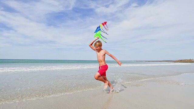 Child hold parachute fly on wind at ocean beach profile image
