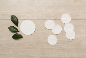 Naklejka na ściany i meble Reusable cotton pads with disposable ones on wooden background, top view
