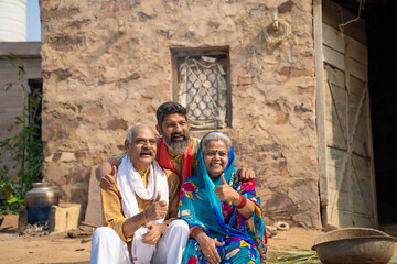 indian farmer family showing thumps up at home