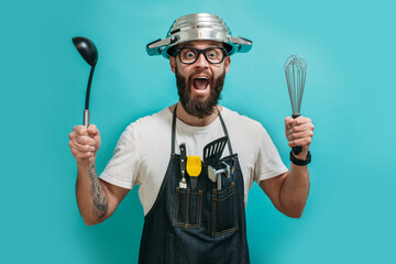 Funny bearded crazy chef with a pan on his head. Cooking. Crazy emotions