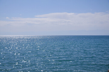 Mountain lake Issyk-Kul, Kyrgyzstan. Tranquil view. Seascape background wavy blue sea and sky with...