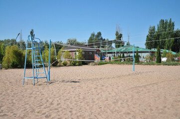 Volleyball court on the sandy beach and a special high chair for the referee. Sports and recreation.