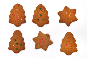Homemade cookies in the form of a Christmas tree and a star on a white background. Close-up