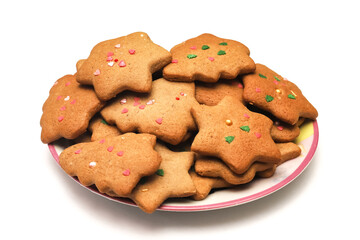 Homemade cookies in the form of a Christmas tree and a star in a plate on a white background. Close-up