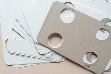 pile of rough cardboard cards with large circle cutouts on blank paper