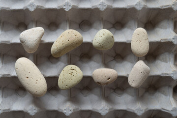 set of brick stones balanced on an egg carton