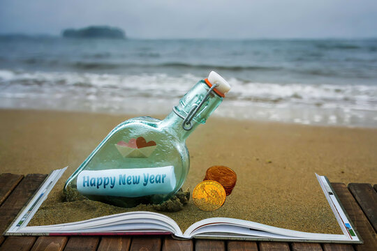 Happy New Year wish in the bottle on beach