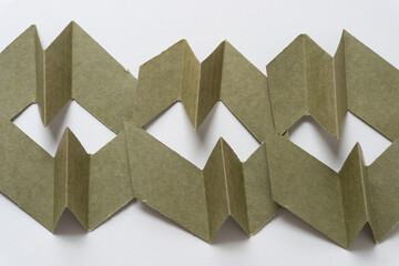cut green paper cards with 3d element arranged horizontally on blank paper