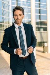 Handsome male model posing wearing a blue suit.