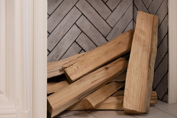 Firewood lies in a niche near the wall-mounted fireplace in the house