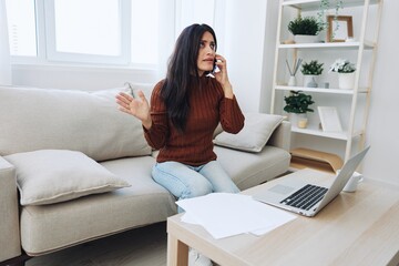 Woman talking on phone angry and sad at home, fight over phone, bad news at work and family