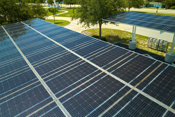 Aerial view of solar panels installed as shade roof over parking lot for parked cars for effective...
