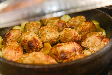 Hot stew meatball with vegetables in tomato sauce closeup in a pot on the table. 