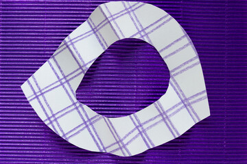 abstract paper ring with plaid, grid, or lattice design on purple foil cardboard with corrugated texture