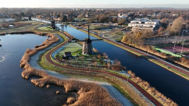 Strijkmolen E, Ouddorp, Alkmaar, North Holland,The Netherlands. Oak octagonal polder mill from 1630. Ironing mills do not drain polders, grind the water from one reservoir to the other. Winter aerial.