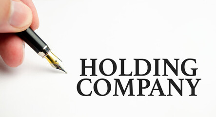 holding company words with pen on white background