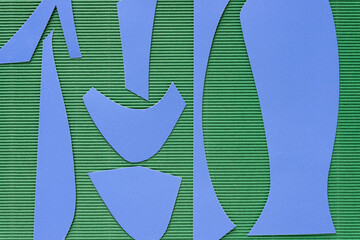 blue paper shapes on green corrugated paper