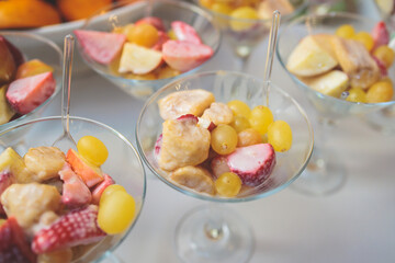 Beautifully decorated catering banquet table with desserts setting, variety of different fruits and berries on corporate Christmas birthday party event or wedding celebration