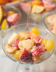 Beautifully decorated catering banquet table with desserts setting, variety of different fruits and berries on corporate Christmas birthday party event or wedding celebration