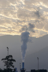 Polluting smoke expelled by the chimney of industry in the interior of the state of Sao Paulo,...