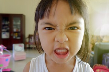 young asian female grinning and look at the camera