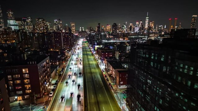 Forwards fly above busy multilane expressway in night metropolis. Aerial scenic hyperlapse shot. New York City, USA