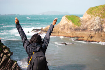 Girl in front of the ocean on the island in Ireland