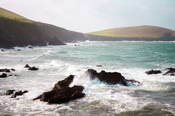 Irish cliff, raging waves crashing on the rock.