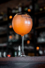 orange drink served in a round glass