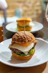 Tasty burger with white crispy ban, beef burger, egg, green lettuce and cheese